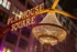 Vibrant Playhouse Square with glowing marquee lights and a stunning illuminated chandelier set against a historic building at night.