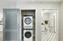 Modern apartment interior with a sleek in-unit laundry setup, stylish bathroom, and elegant tile flooring.