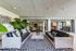 Luxurious lounge with elegant outdoor seating, lush plants, and stylish decor