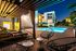 Luxurious pool area with cabana and ambient lighting, perfect for evening relaxation in a stunning apartment complex.