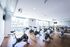 Modern, sunlit gym with multiple spinning bikes, sleek wooden flooring, and large mirrors for an invigorating workout experience