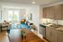 Modern one bedroom apartment living space featuring a cozy sofa, elegant decor, and a sleek kitchen