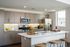Modern kitchen with sleek cabinetry, stainless steel appliances, and a stylish countertops with wooden stools
