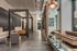 Sleek and modern lobby with elegant lighting and contemporary seating in a luxurious apartment building.
