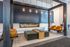 Modern lounge area featuring sleek suspended seating, a stylish fireplace, and elegant pendant lighting, creating a warm and inviting ambiance.