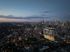 Breathtaking panoramic cityscape view at dusk featuring modern high-rise buildings illuminated against the stunning twilight sky.