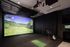 Luxurious indoor golf simulator room with scenic virtual golf course, perfect for enthusiasts seeking a realistic practice experience.