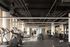 Modern fitness center with state-of-the-art equipment and natural lighting, featuring treadmills, weight machines, and free weights.