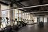 Contemporary gym with state-of-the-art equipment, abundant natural light, and sleek design for an invigorating workout experience.