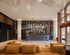 Sophisticated apartment lobby featuring modern lighting, stylish seating, and an elegant reception area with artistic decor.