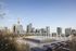 Luxurious rooftop pool with sun loungers offers stunning views of the city skyline, perfect for relaxation and leisure.