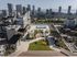 Luxurious rooftop deck showcasing a sparkling pool, elegant seating areas, and panoramic city skyline views.