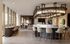 Elegant communal lounge with modern bar seating, stylish lighting, and expansive windows providing natural light.