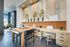 Modern workspace with a sleek wooden desk, chic decor, and vibrant indoor plants, exuding a creative and inviting atmosphere.
