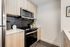 Contemporary kitchen with modern stainless steel appliances, sleek cabinetry, and stylish dark backsplash.