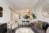 Contemporary open-plan living space with stylish kitchen island, chic bar stools, and elegant decor accents.