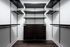 Contemporary walk-in closet with sleek dark wood shelves and drawers, offering ample storage space.