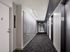 Contemporary apartment hallway with sleek modern design, featuring abstract wall art and stylish lighting.