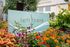 Vibrant urban garden with colorful flowers framing a modern 'Left Bank' sign, offering an inviting glimpse into contemporary city living.