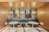 Chic dining nook with modern art, stylish navy tufted seating, and warm wood paneling.