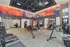 Vibrant, state-of-the-art fitness center featuring modern exercise equipment and colorful wall art for an energizing workout experience.