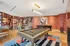 Luxurious game room featuring a stylish pool table, chic patterned walls, and plush seating in a vibrant and relaxing atmosphere.