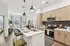 Chic open-concept kitchen and living area with modern appliances, stylish pendant lighting, and elegant wooden cabinetry.