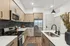 Modern kitchen featuring sleek stainless steel appliances, elegant cabinetry, and a spacious island with a stylish faucet, illuminated by contemporary lighting.