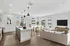 Bright and modern open-concept living area with sleek kitchen, spacious dining space, and cozy lounge in a sunlit apartment.