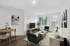 Inviting living area featuring modern decor, plush seating, natural light through large windows, and a sleek dining space.