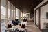 Elegant lounge area with modern seating, floor-to-ceiling windows, and stylish lighting in an upscale apartment setting.