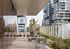 Chic urban terrace with modern outdoor seating and lush greenery, offering cityscape views.