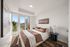 Elegant bedroom with a plush bed, chic decor, and a stunning view through large windows, perfect for modern city living.