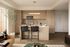 Contemporary kitchen with sleek wooden cabinets, a modern island, and cozy bar seating, enhanced by warm lighting and elegant decor.