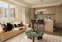 Bright and modern open-concept living area featuring a stylish kitchen with sleek cabinetry and a cozy sofa next to floor-to-ceiling windows.
