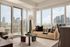 Stylish apartment living room with floor-to-ceiling windows offering breathtaking city views, featuring a cozy beige sofa, chic glass coffee table, and modern decor.