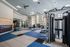 Modern fitness room with advanced exercise equipment, spacious layout, and vibrant design elements for an energetic workout experience.