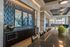 Luxurious modern apartment interior featuring elegant wall art, sleek kitchen counter with contemporary decor, and stylish pendant lighting for a sophisticated ambiance.