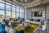 Luxurious urban living room with panoramic city views, elegant seating, and modern decor.