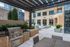Chic urban apartment outdoor area with modern BBQ grill, stylish furnishings, and elegant lounge chairs for a luxurious city living experience.