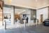 Contemporary apartment entrance at Aris Market Square with modern glass doors, sleek design, and inviting lighting.