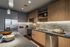 Modern kitchen with sleek stainless steel appliances, stylish under-cabinet lighting, and elegant wood cabinetry.