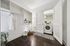 Sleek laundry room with modern washer, open shelving, and stylish wooden flooring offering ample storage and elegance.