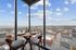 Luxurious cityscape dining experience with spectacular panoramic views from a modern high-rise apartment.