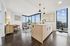 Contemporary apartment interior featuring a sleek kitchen island, open-concept living area with stylish decor, and floor-to-ceiling windows showcasing breathtaking city views.
