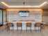Sophisticated co-working space featuring a sleek marble table, chic leather chairs, and ambient lighting, perfectly designed for stylish gatherings.