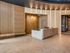 Sophisticated lobby featuring a modern reception desk with sleek beige tones and elegant wall textures.
