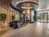 Luxurious lobby with elegant lighting, modern seating, and floor-to-ceiling windows, creating an inviting entrance.