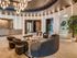 Luxurious apartment lobby with modern chandelier, plush seating, and elegant decor.