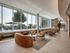 Luxurious lounge with panoramic windows, elegant seating, and abundant natural light creating an inviting atmosphere.